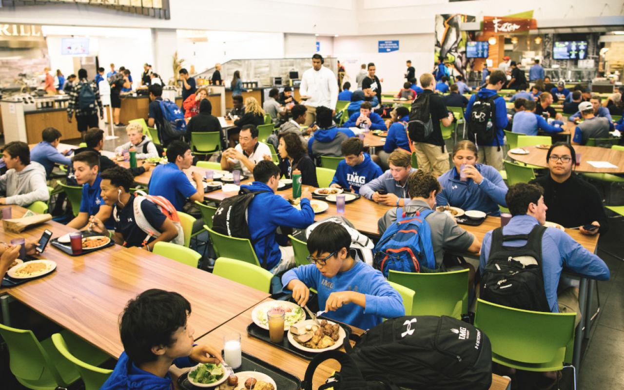 students eat a meal at the campus center at IMG Academy