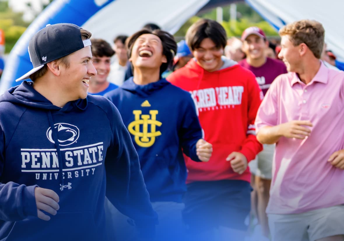 Male college athletes laughing together wearing university gear