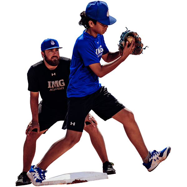 IMG Academy baseball camper learns how to throw from IMG Academy baseball coach