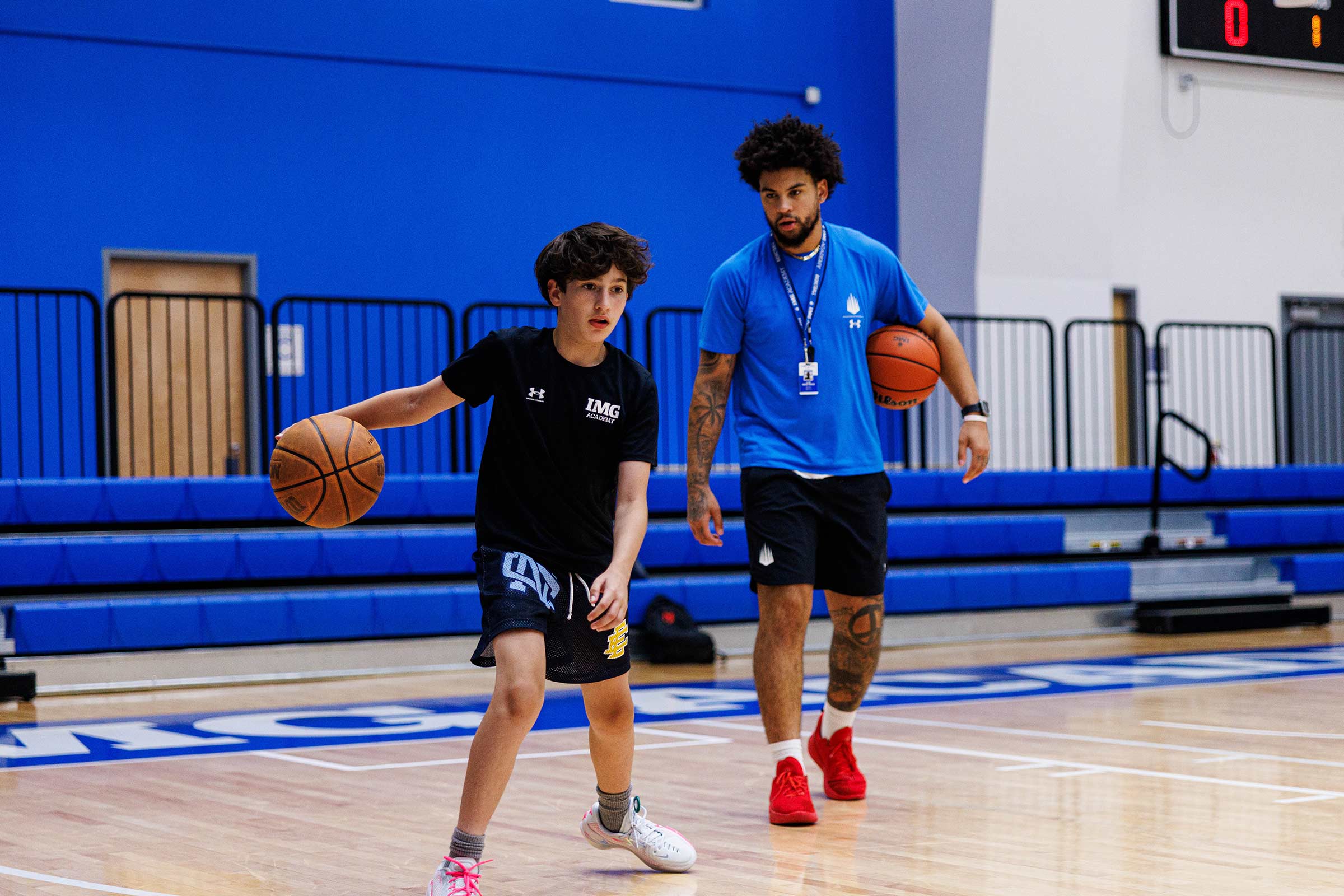 Athlete playing basketball with a coach