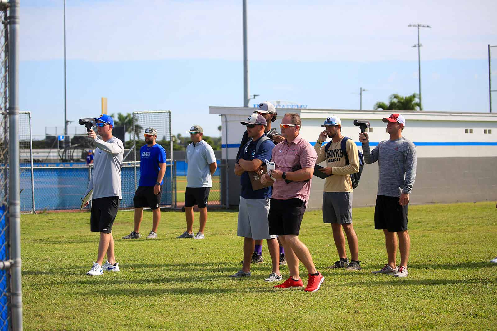 Baseball scouts watch IMG Academy baseball players practicing