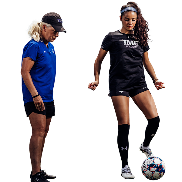 Girls soccer camper learning from IMG coach
