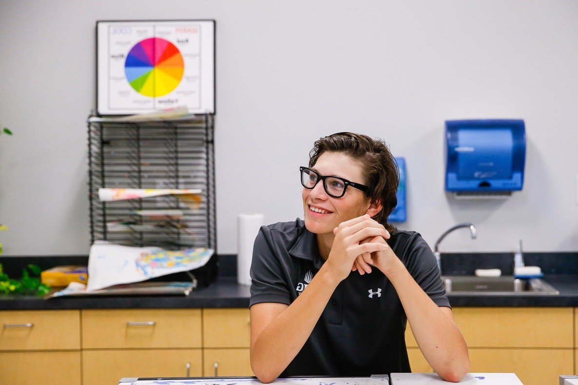Male Student with Glasses Sitting in Classroom | IMGAcademy.com