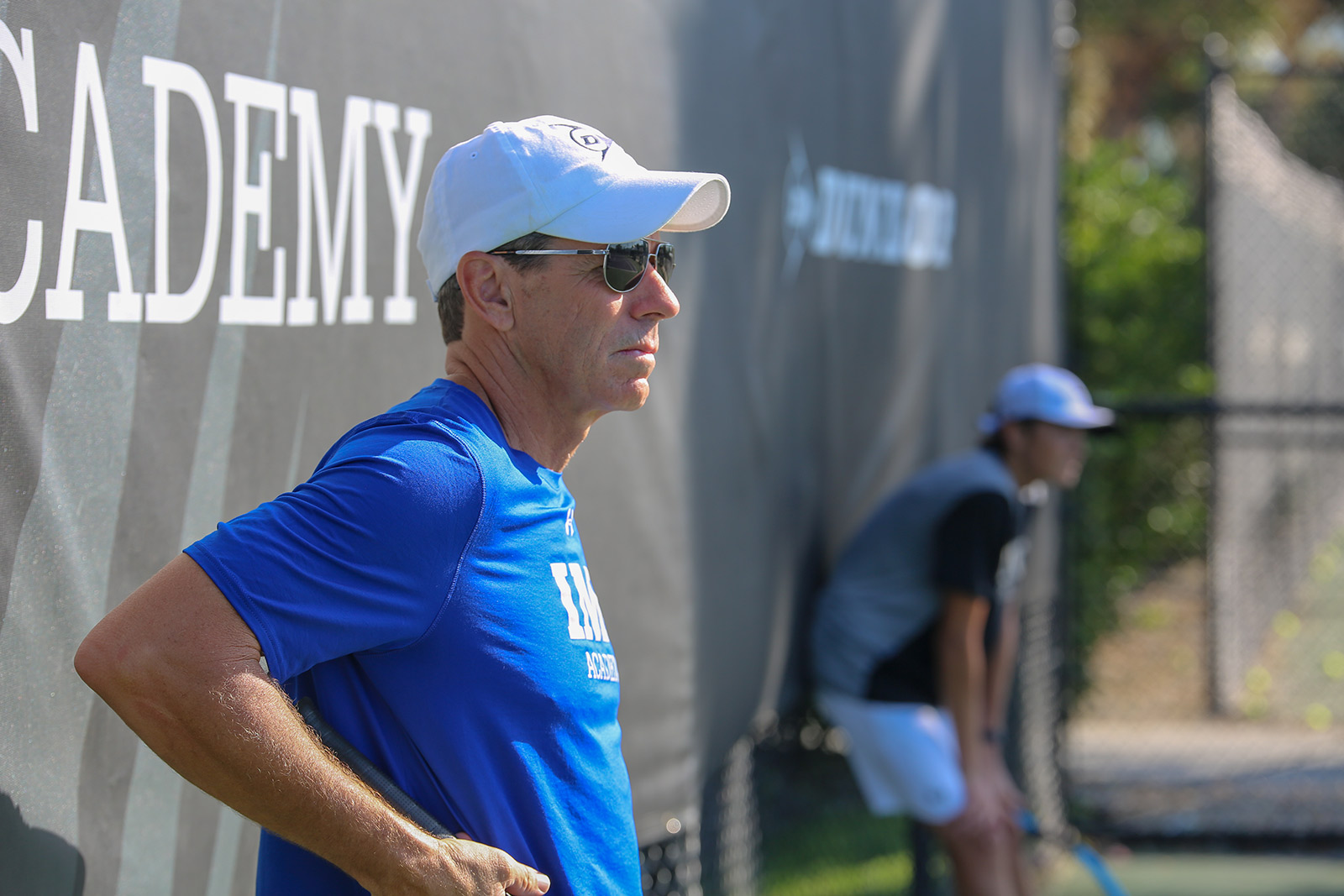 jimmy arias watches tennis practice from IMG Academy courts