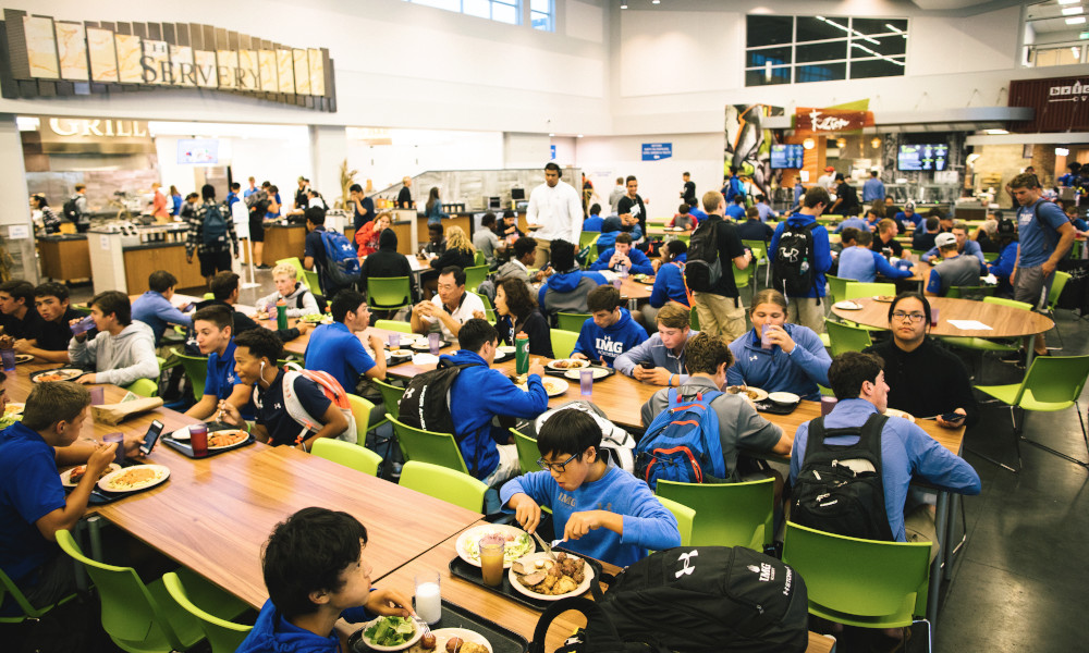 students eat a meal at the campus center at IMG Academy