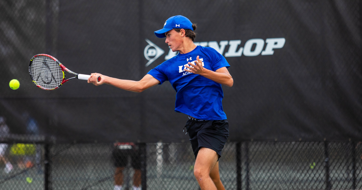 tennis player hits ball with racket