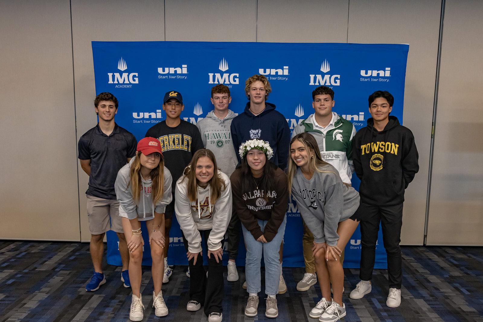 IMG Academy signing day athletes stand in front of backdrop