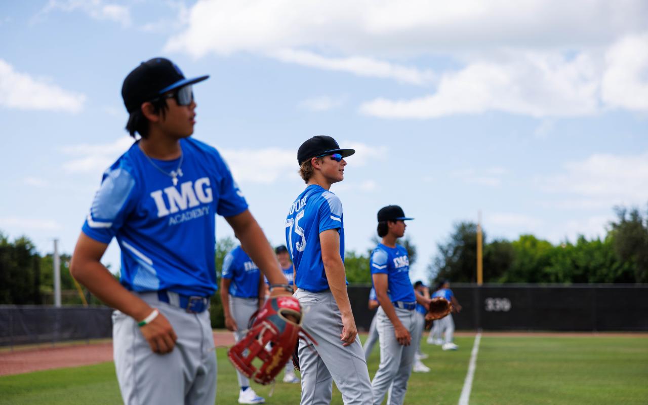 IMG Academy Baseball student-athletes lined up on a baseball field doing throwing exercises