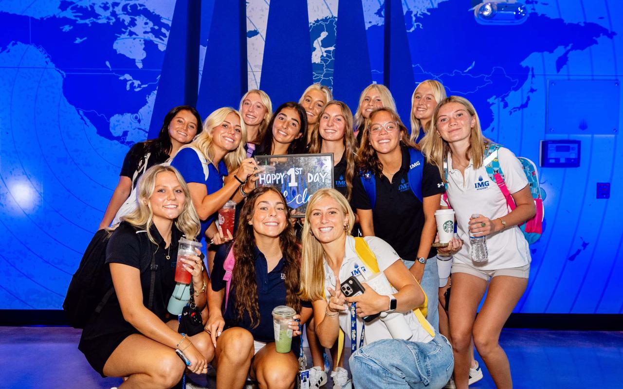 A large group of female IMG Academy student athletes posing for a picture on their first day
