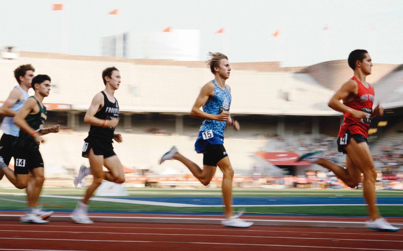 IMG Academy Track and Field competitors running a race on an outdoor track