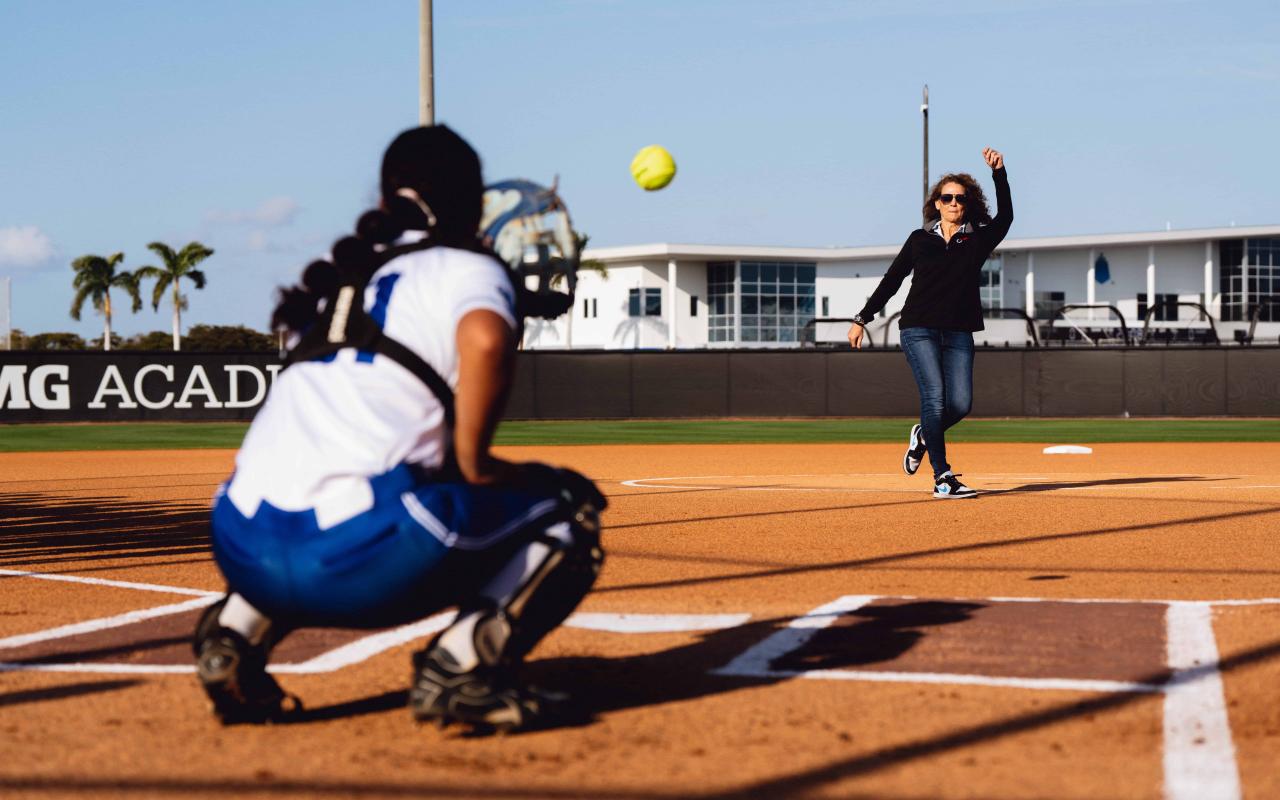 IMG Academy Softball coach throwing a pitch to the catcher during practice