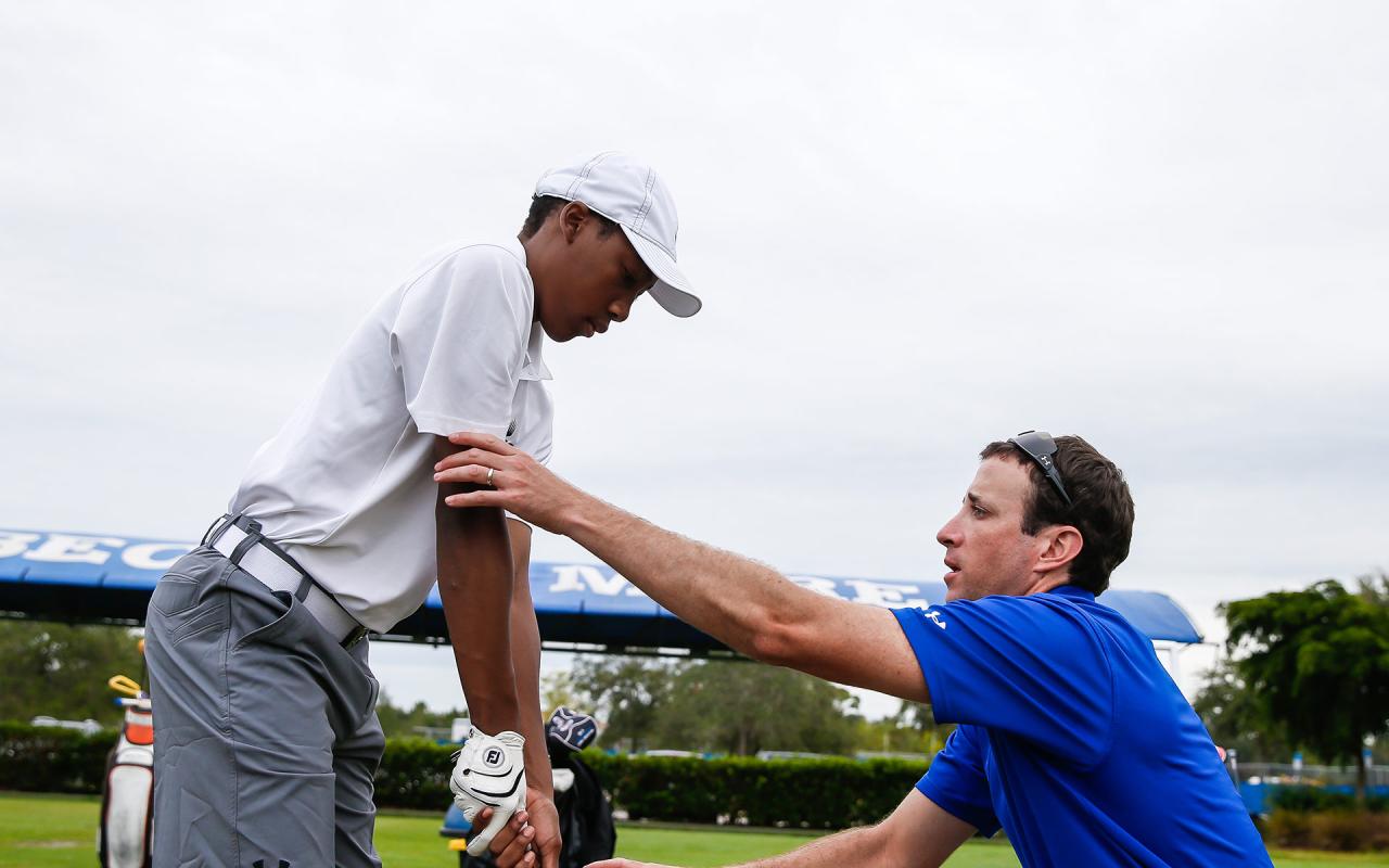 Student getting golf lessons