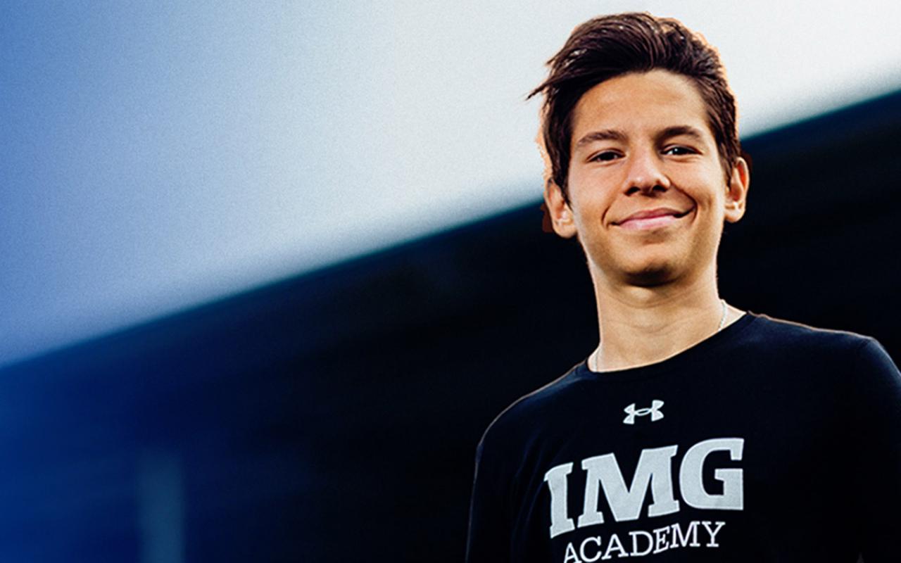 IMG Academy camper proudly stands on soccer field