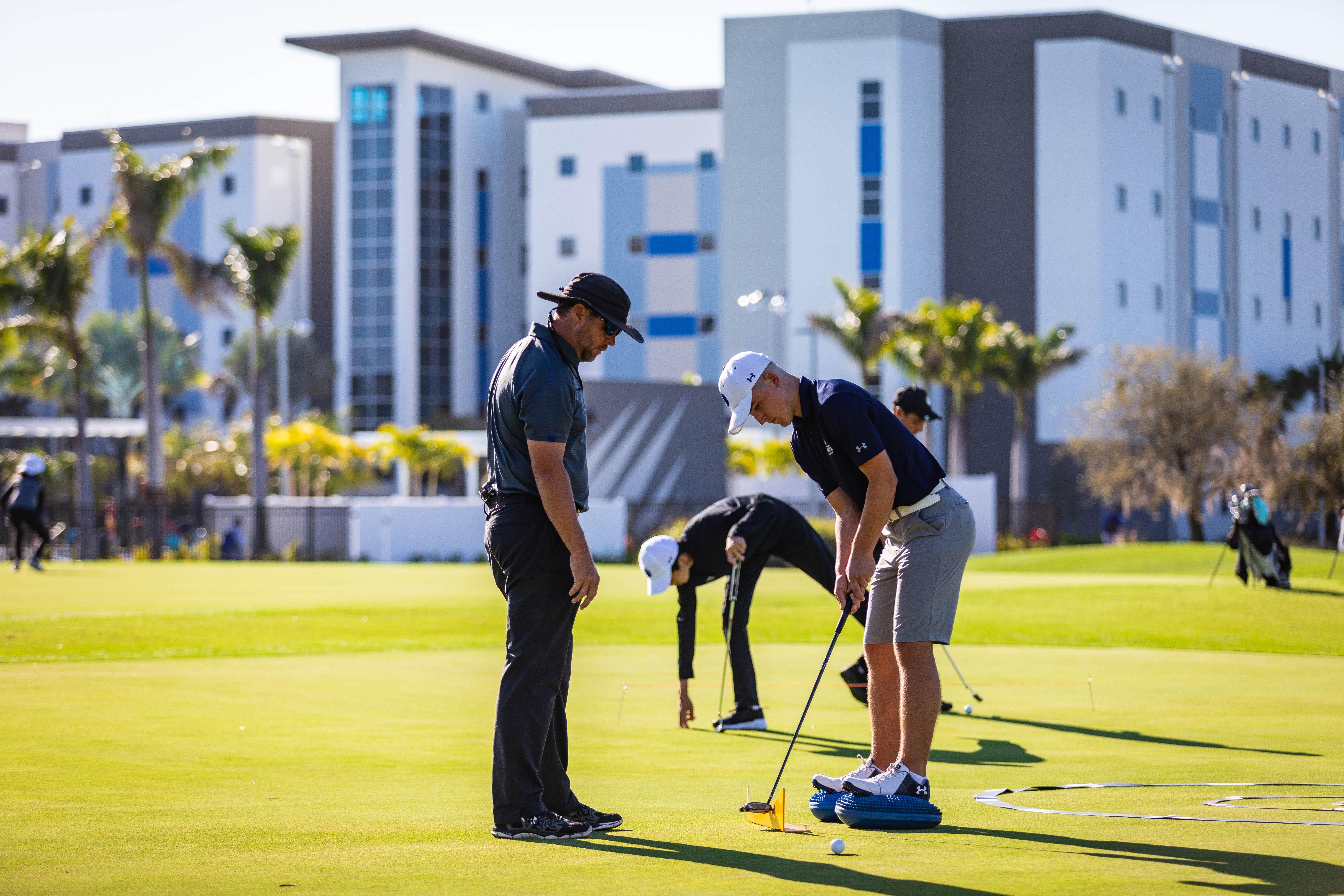 IMG Academy golf camper learning how to putt with coach